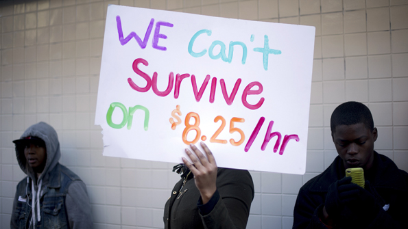 Protesters calling for higher wages for fast-food workers stand outside a McDonald's restaurant in Oakland, California December 5, 2013. The group, which numbered about 200, shut down the store for more than half an hour as part of a daylong nationwide strike demanding a $15 dollar minimum wage. REUTERS/Noah Berger (UNITED STATES - Tags: BUSINESS CIVIL UNREST FOOD) - RTX165IS :rel:d:bm:GF2E9C51PJK01